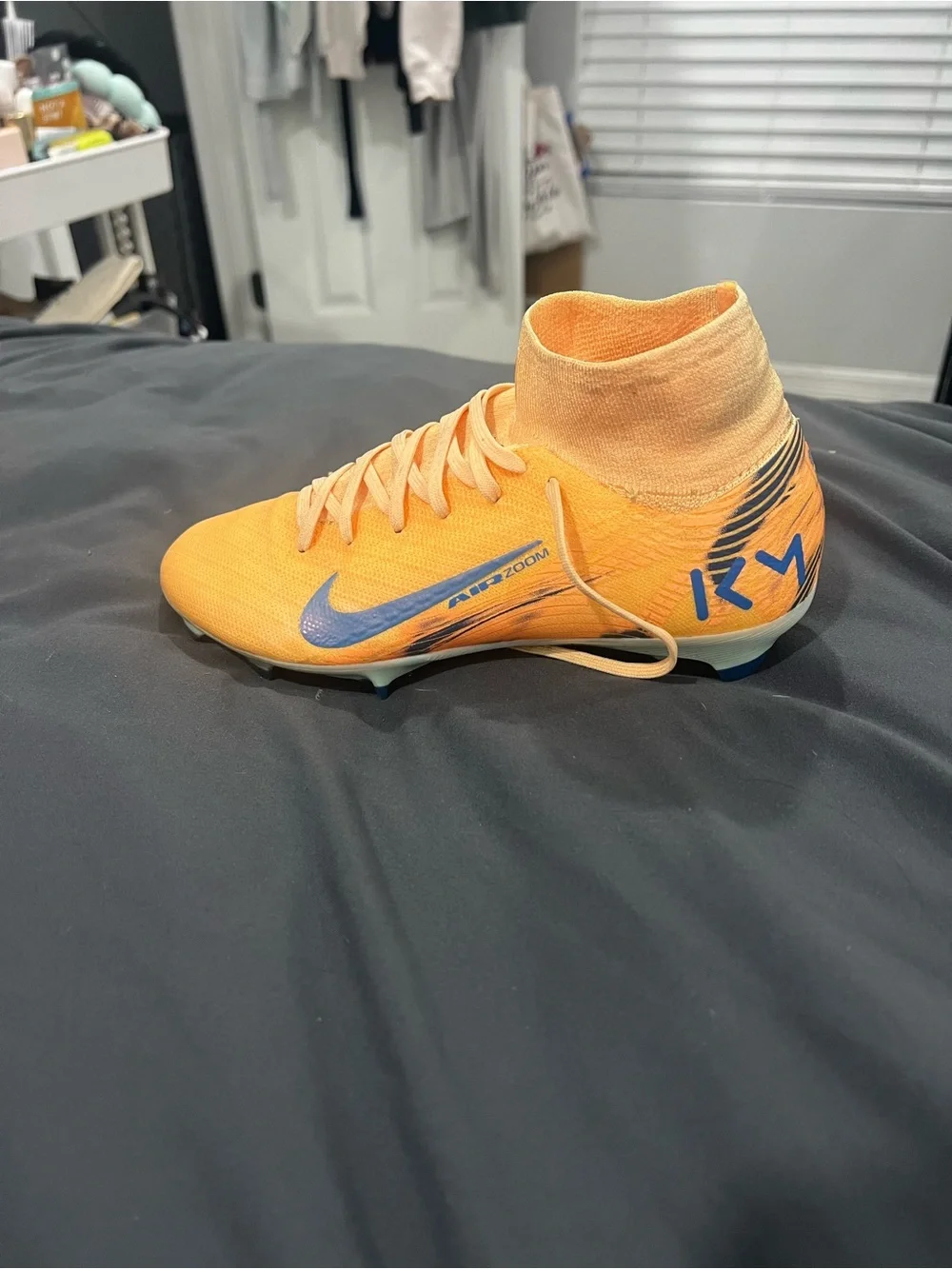 Nike Kids Orange High-Top Soccer Shoes with Blue Swoosh